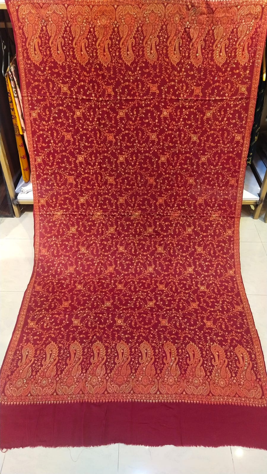 Deep maroon base with rust-gold needle embroidery.