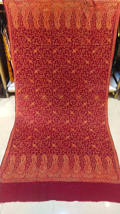 Deep maroon base with rust-gold needle embroidery.